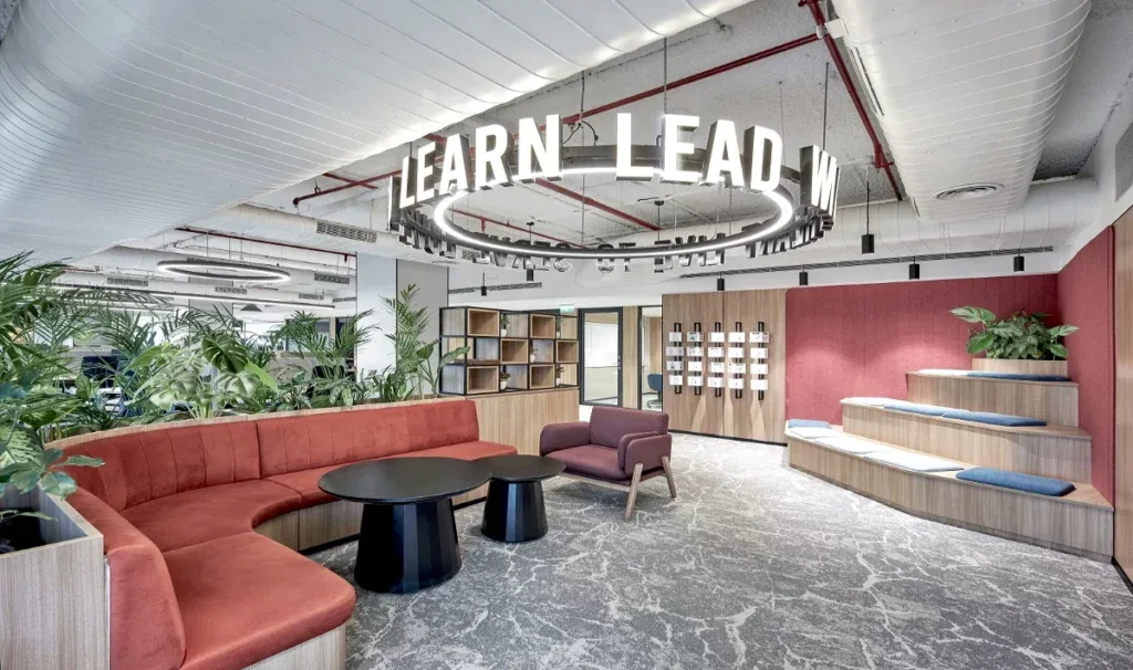Workspace holding both layouts: open desks on one side, partitioned cubicles on the other