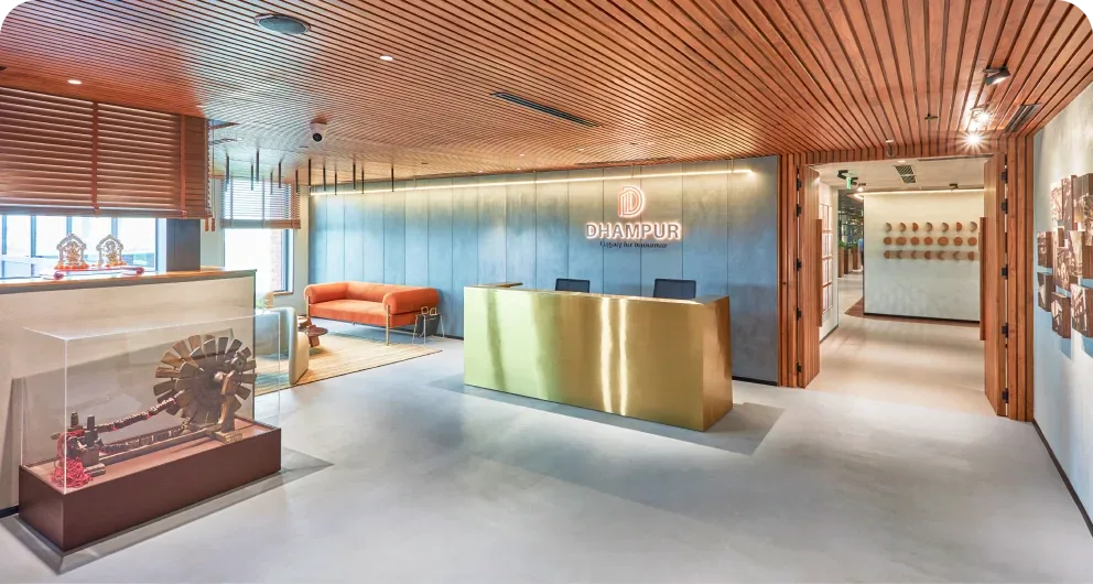 Dhampur reception: wood-slat ceiling, brass front desk, heritage display