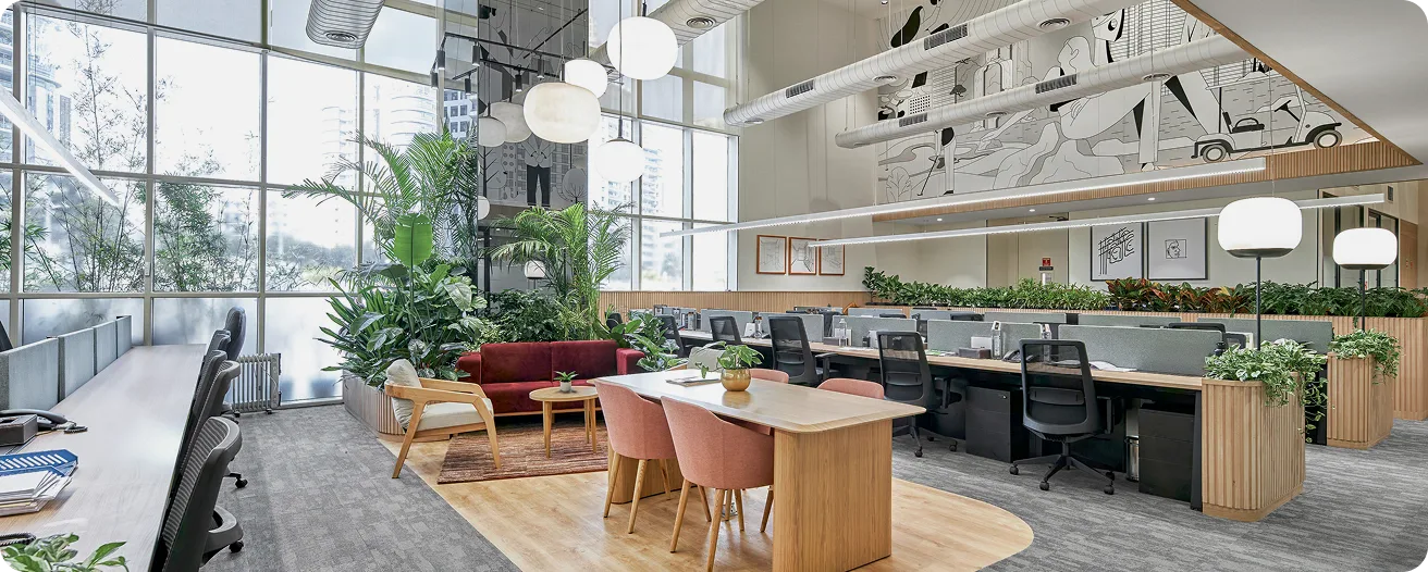 Double-height Officebanao workspace: glass facade, planting, and collaborative tables